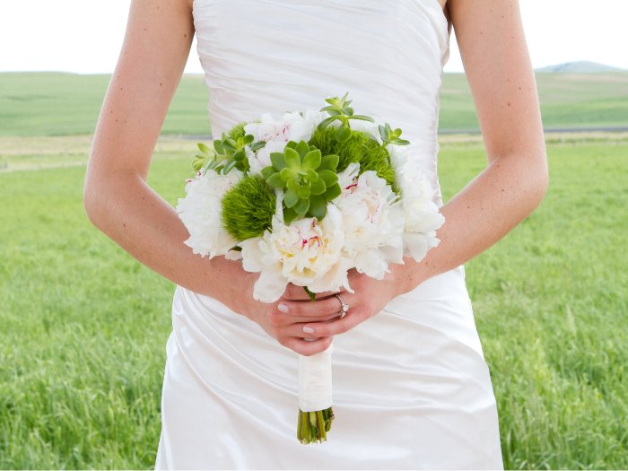 A simple and elegant succulent wedding bouquet, featuring a minimalist design with soft greenery and subtle succulents, perfect for a modern, understated wedding