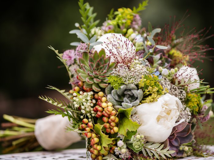 A stunning blend of succulents and soft pastel roses, creating a romantic and timeless handheld wedding bouquet