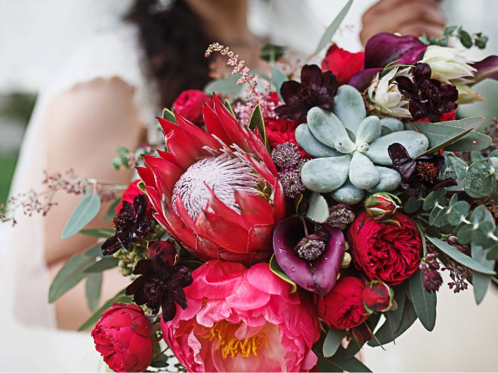 A stunning succulent bouquet accented with golden-hued dahlias and lush greenery, ideal for an autumn wedding